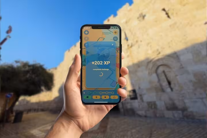 Hand holding smartphone displaying +202 XP completed challenge screen on Jerusalem walking tour game app