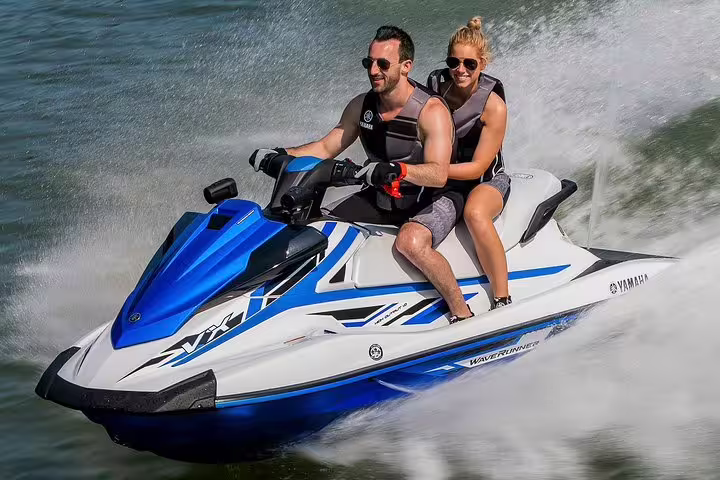 Jet ski tour from San Antonio Ibiza with two riders, high-speed spray on route to Margaritas Islands