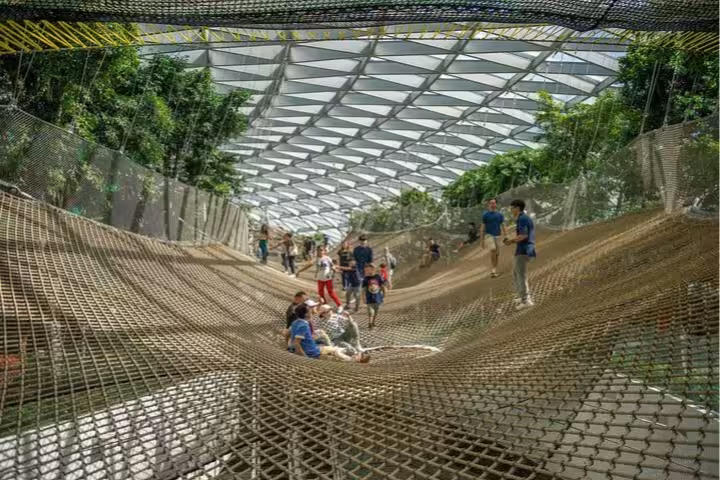 Visitors relaxing on Jewel Changi Airport Canopy Park Sky Nets, included with Canopy Park admission ticket