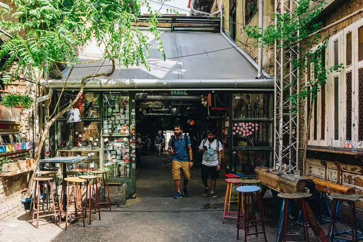 Ruin bar courtyard in Budapest Jewish District with stools and visitors on a private walking tour