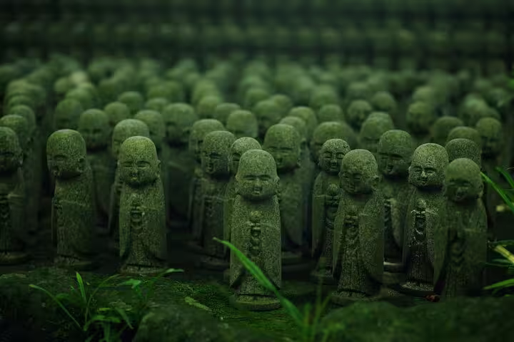 Rows of moss-covered Jizo statues in Kamakura, showcasing spiritual heritage on the Tokyo to Kamakura private tour.