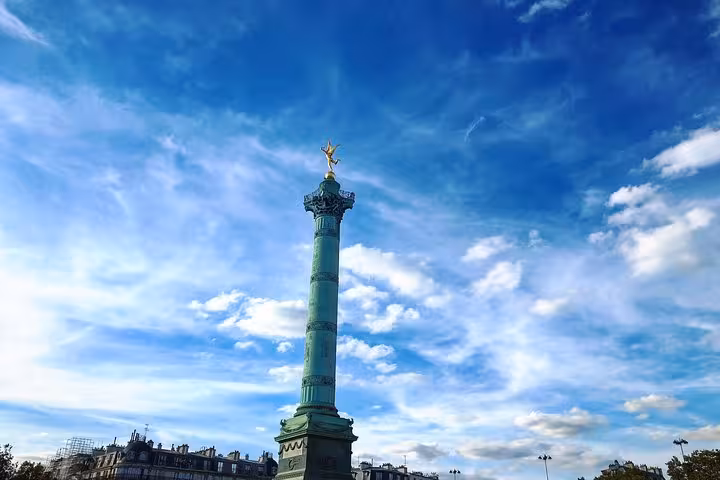 July Column with golden statue at Place de la Bastille, Paris, under blue sky