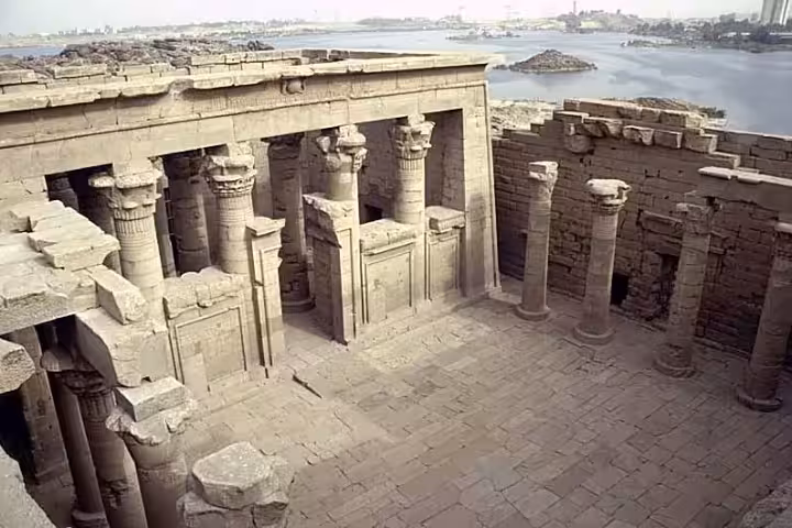 Ancient Kalabsha Temple courtyard with carved columns overlooking the Nile River near Aswan