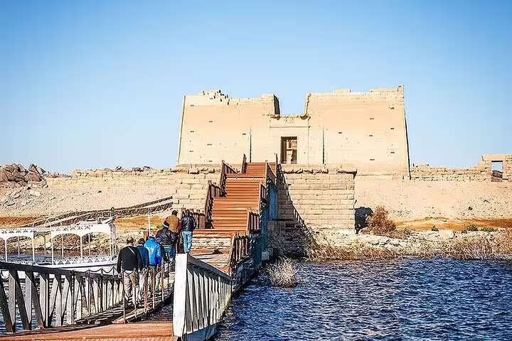 Visitors crossing a pontoon bridge to Kalabsha Temple on Lake Nasser, Aswan private guided tour Egypt