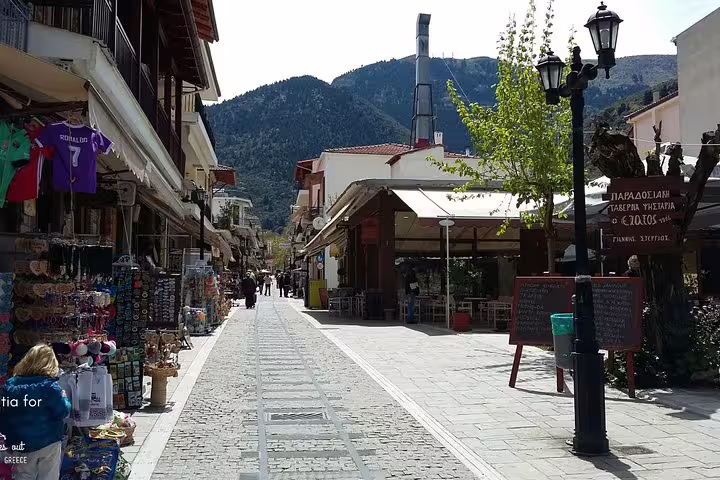 Kalavryta town main street with shops and cafes in the mountains, stop on Cave of Lakes day tour