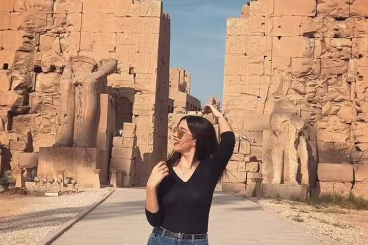 Visitor posing along Karnak Temple avenue, Luxor highlights on private shore excursion from Safaga Port