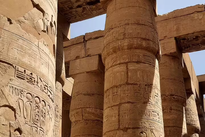 Karnak Temple columns with ancient hieroglyphs, seen on private Luxor day tour from Cairo by plane