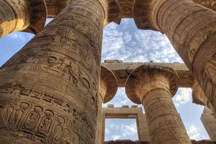 Close-up of towering Karnak Temple columns with hieroglyphs in Luxor on a 3-day private tour from Cairo by flight