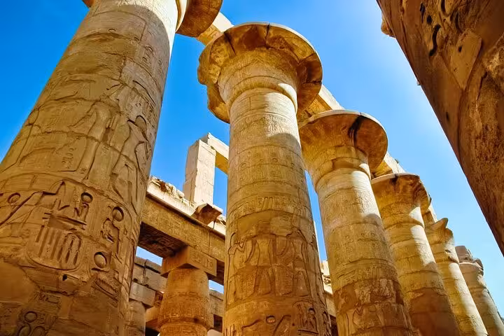 Karnak Temple columns with ancient hieroglyphs in Luxor on a private full-day tour from Hurghada