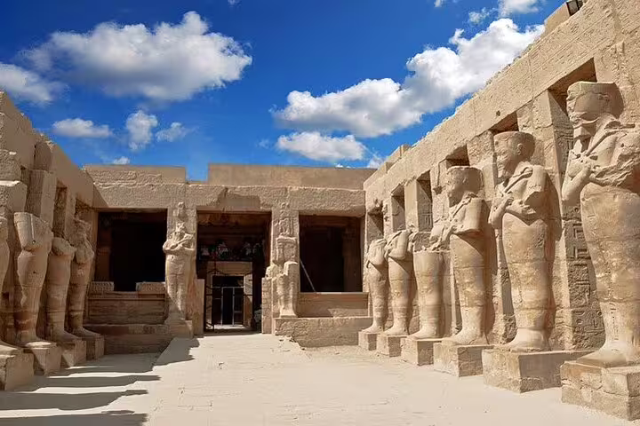 Karnak Temple courtyard with ancient statues, highlights on Luxor day tour by bus from Hurghada