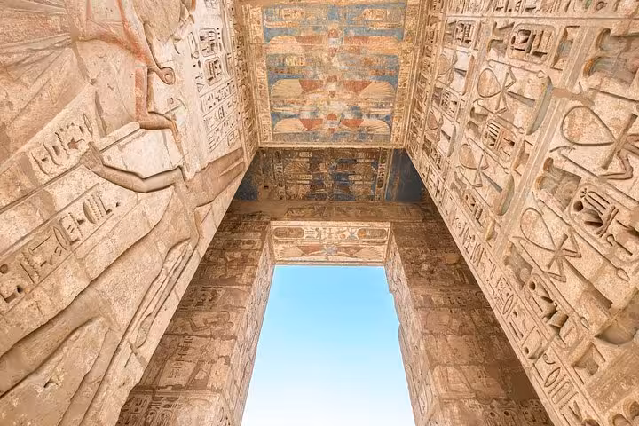 Karnak Temple gateway with carved hieroglyphs and painted ceiling on private Luxor day trip from Hurghada