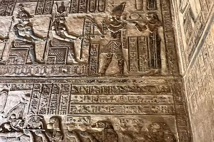Discover detailed hieroglyphic carvings depicting ancient Egyptian deities at Karnak Temple.