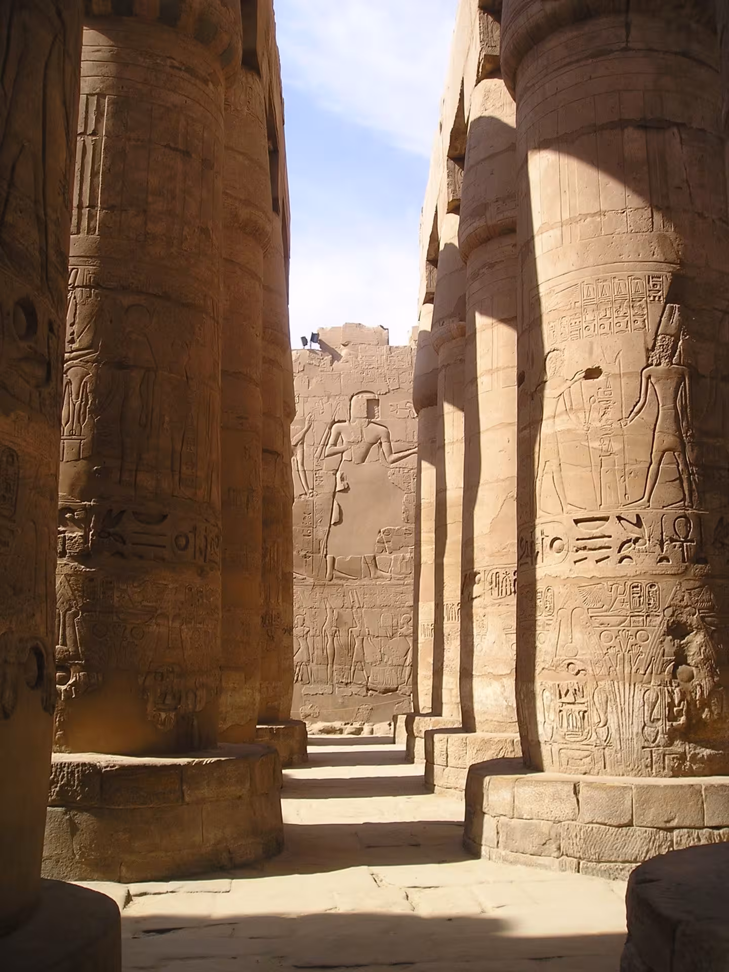 Massive hieroglyph-covered columns inside the Great Hypostyle Hall at Karnak Temple, Luxor, Egypt