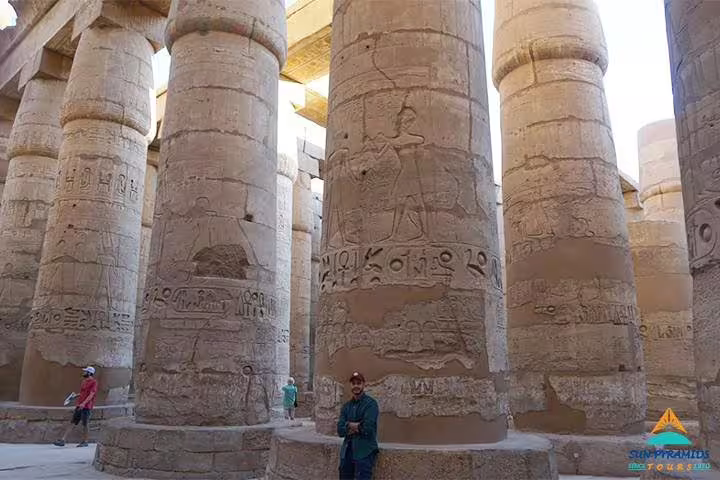 Karnak Temple hypostyle hall columns with hieroglyphs, a highlight of the 8-day Luxor Nile cruise Cairo trip
