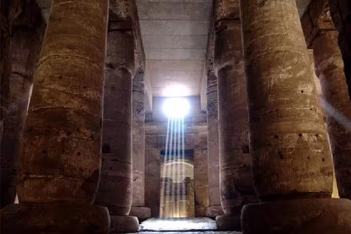 Sunbeams inside Karnak Temple hypostyle hall on private overnight Luxor tour from Cairo by flight