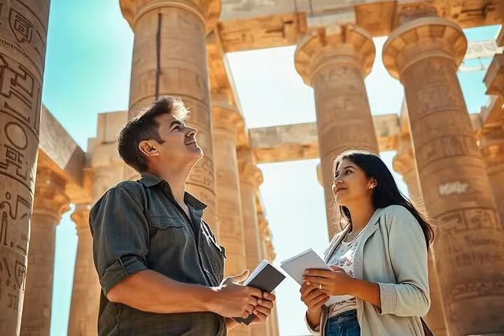 Travelers admire Karnak Temple columns on Luxor day trip by plane from Sharm El Sheikh, Egypt tour