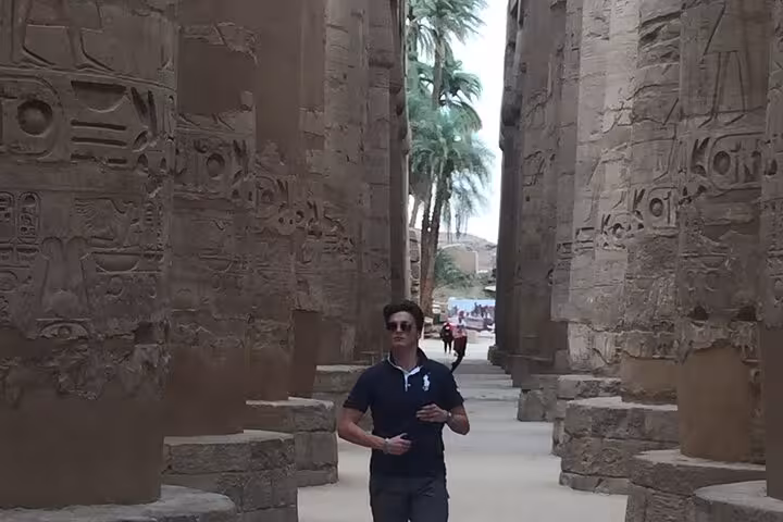 Private guide tour at Karnak Temple, Luxor, from Cairo by domestic flight, walking among ancient hieroglyphs