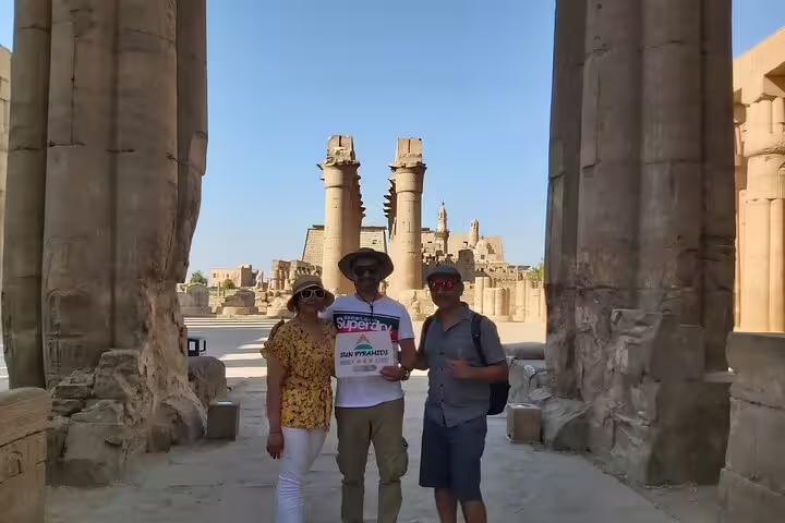 Guests inside Karnak Temple columns in Luxor on a private Cairo to Luxor sleeper train trip