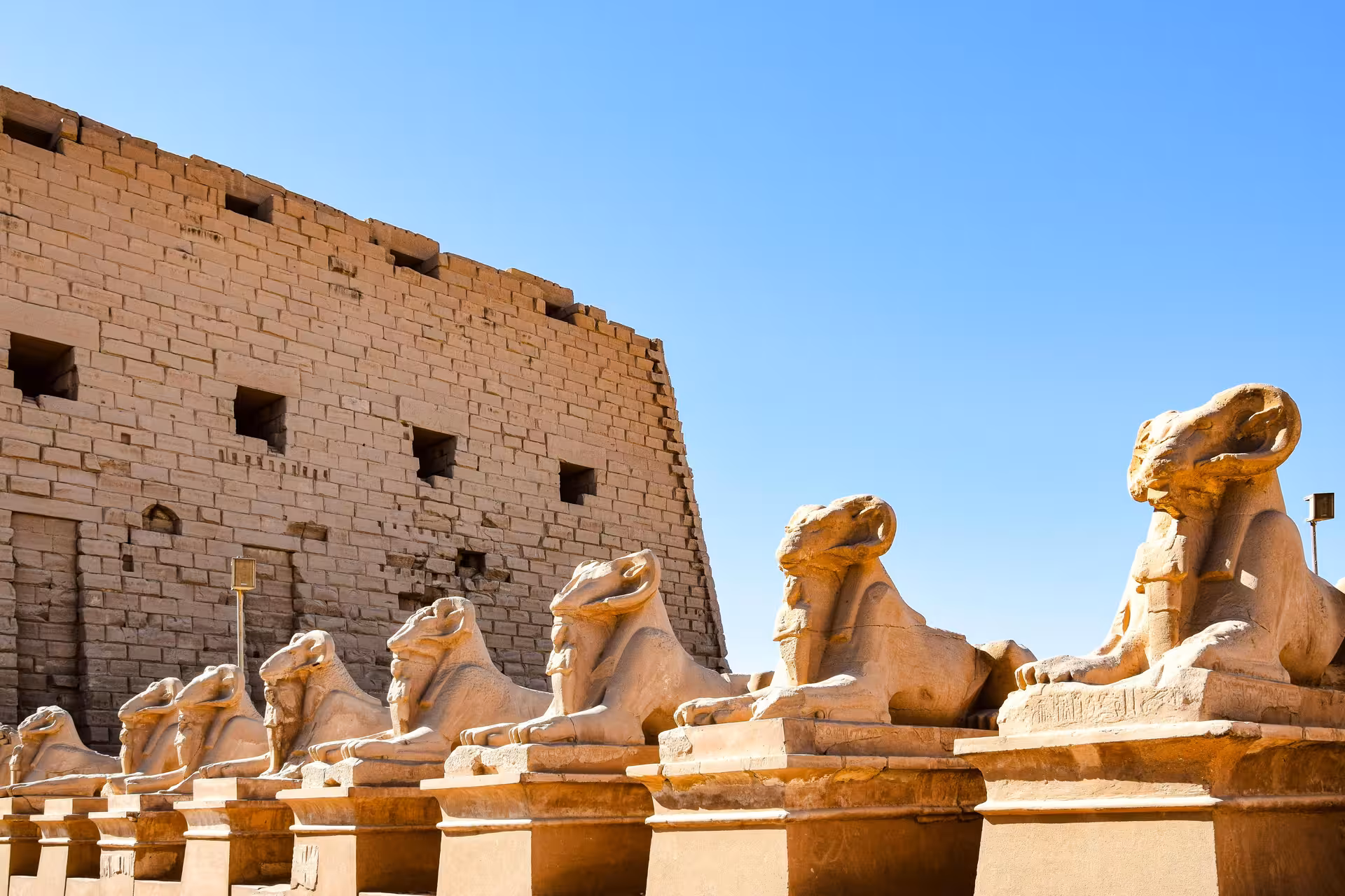 Row of ram-headed sphinx statues lining the avenue at Karnak Temple, Luxor, Egypt