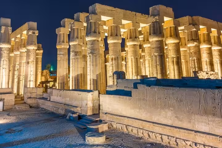 Illuminated Karnak Temple columns at night in Luxor, featured on Sharm El Sheikh to Luxor day tour by plane