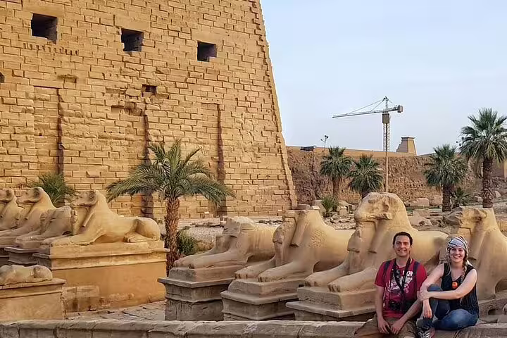 Visitors beside ram-headed sphinxes at Karnak Temple, Luxor private day tour from Cairo by plane, Egypt