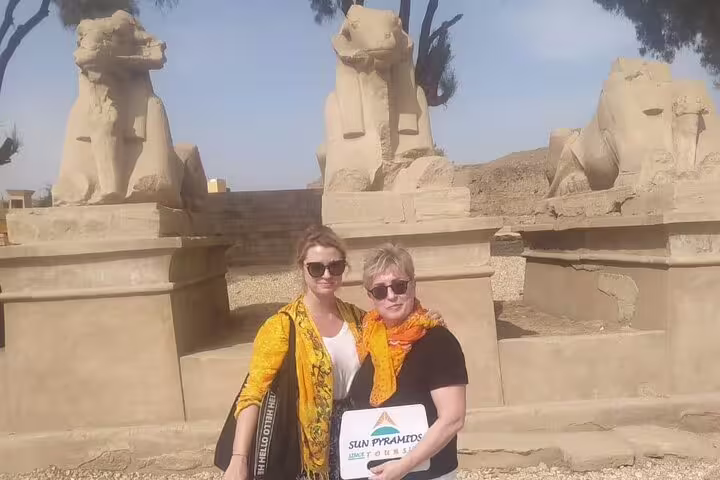Tourists at Karnak Temple ram-headed sphinx statues, Luxor East Bank sightseeing tour in Egypt