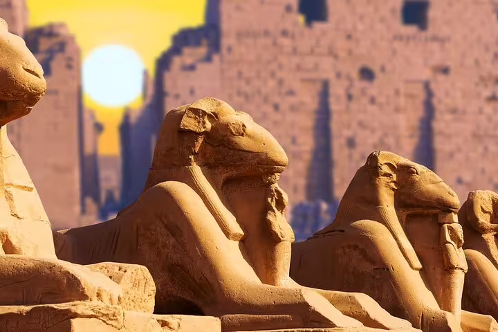 Ram-headed sphinx statues at Karnak Temple at sunset, Luxor highlights on a private Cairo to Luxor flight tour