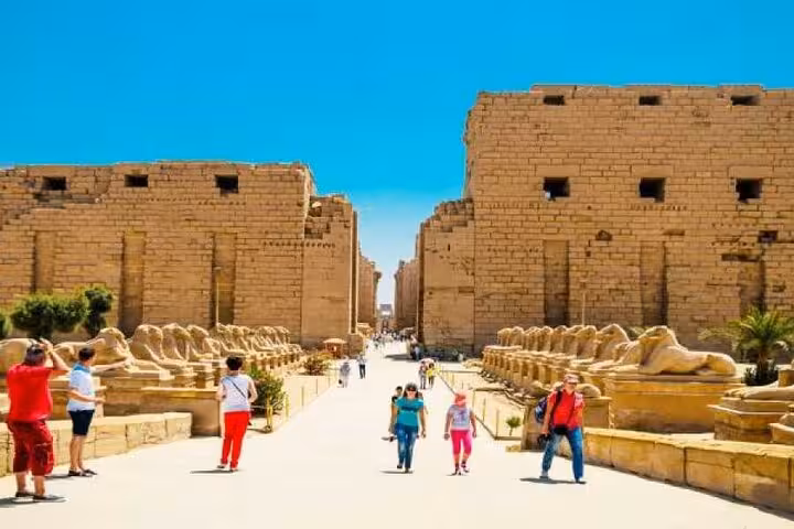 Tourists walking the avenue of sphinxes at Karnak Temple, part of the 2-day Sharm El Sheikh to Cairo and Luxor tour