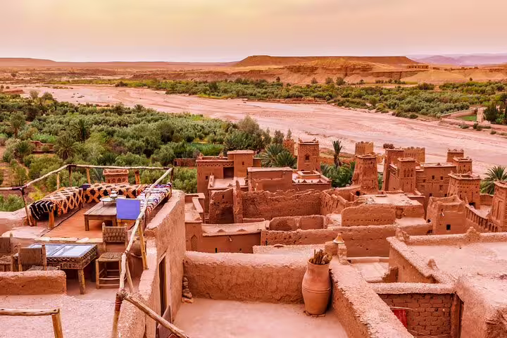 Panoramic view of Kasbah Ait Benhaddou adobe rooftops and Ounila Valley on a day trip from Marrakech