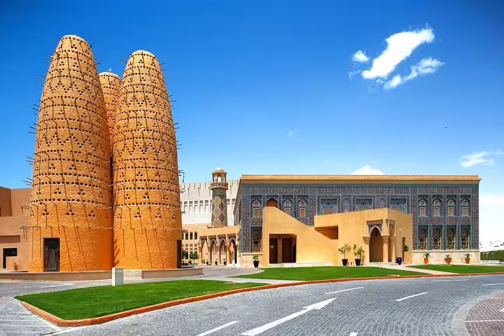 Traditional architecture at Katara Cultural Village, featuring clay pigeon towers, on the Doha City Tour.