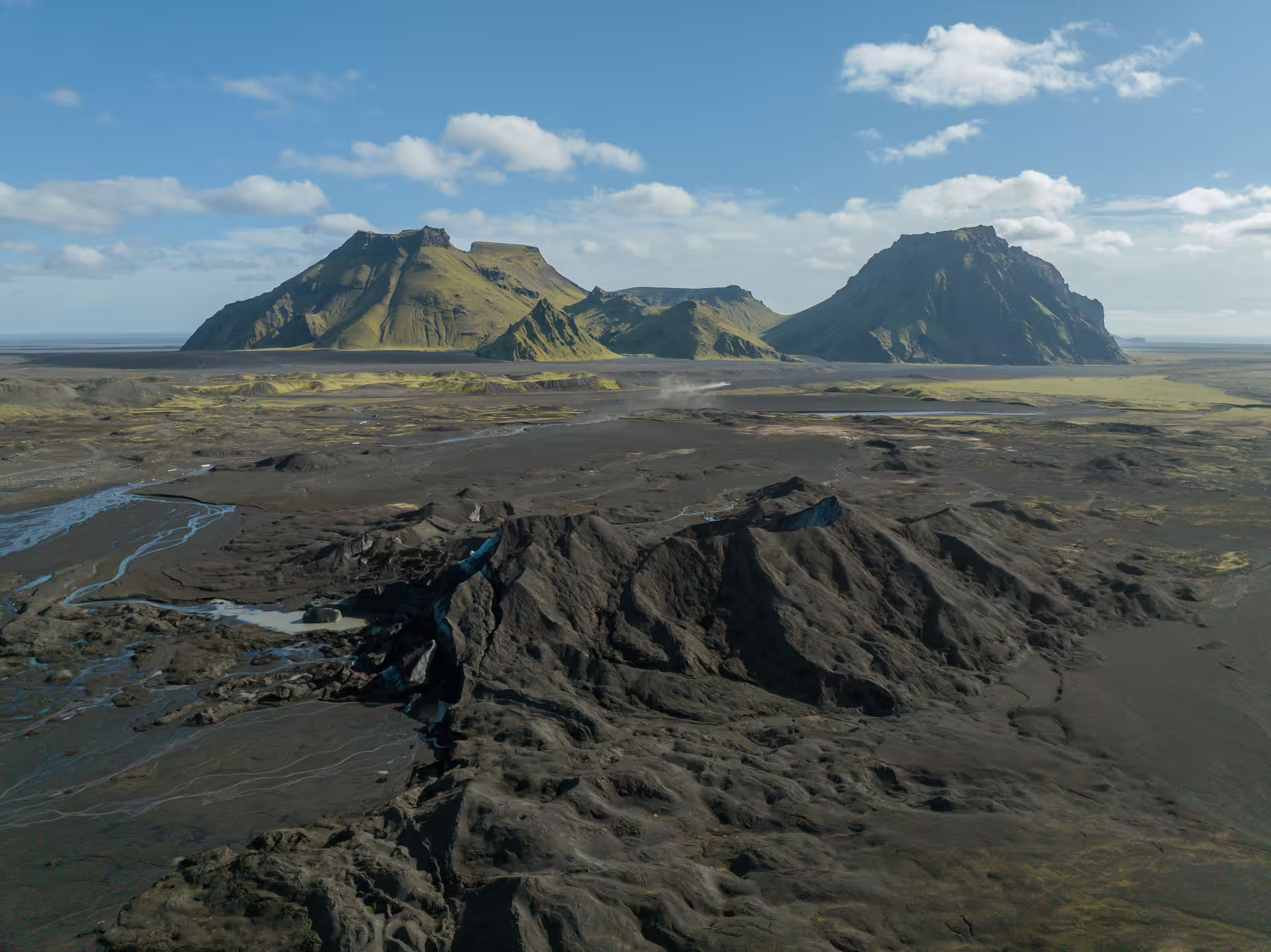 Aerial view of Katla Glacier volcanic black sand landscape with dramatic mountains on a full-day guided tour in Iceland