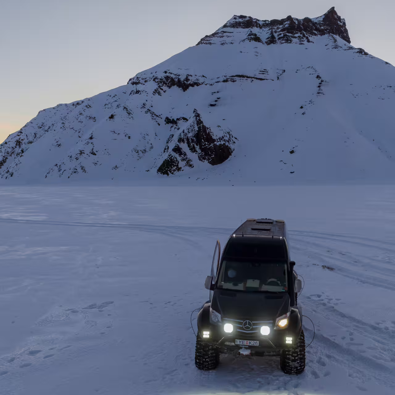 Super jeep adventure on Katla glacier snowfield with dramatic snowy mountain backdrop on Iceland South Coast tour