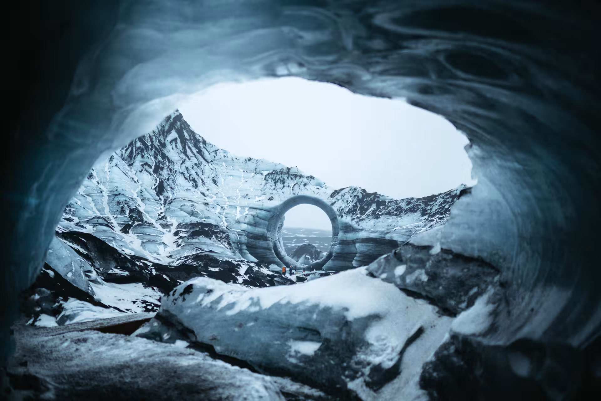 View from inside Katla ice cave toward a circular ice arch, South Iceland private glacier cave tour