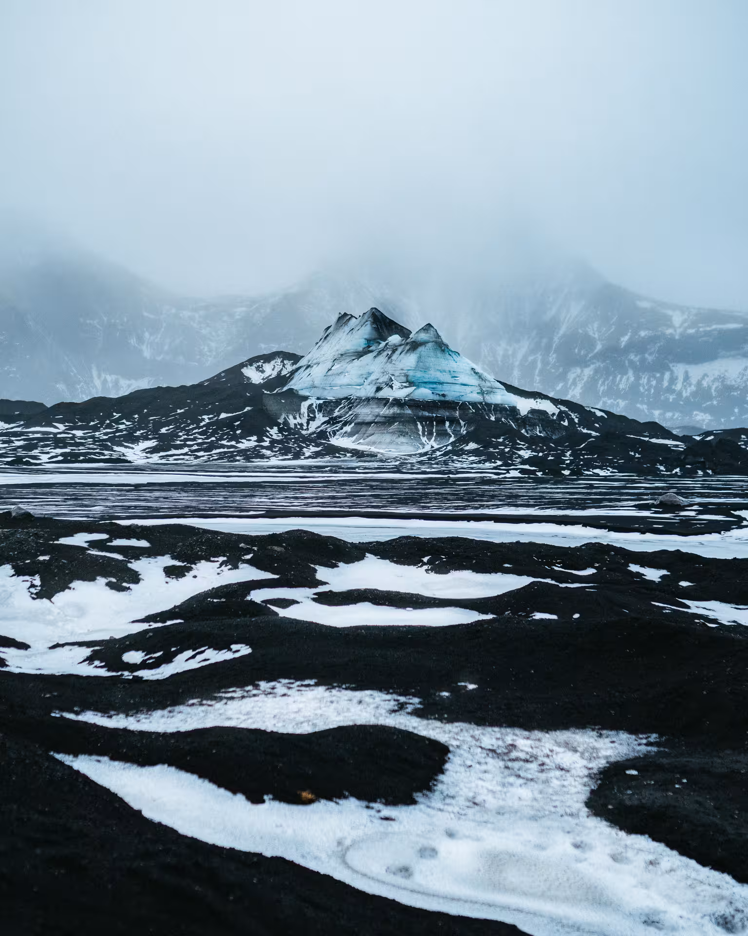 Snowy black sand plain with blue glacier ice near Katla, scenic stop on a private ice cave tour