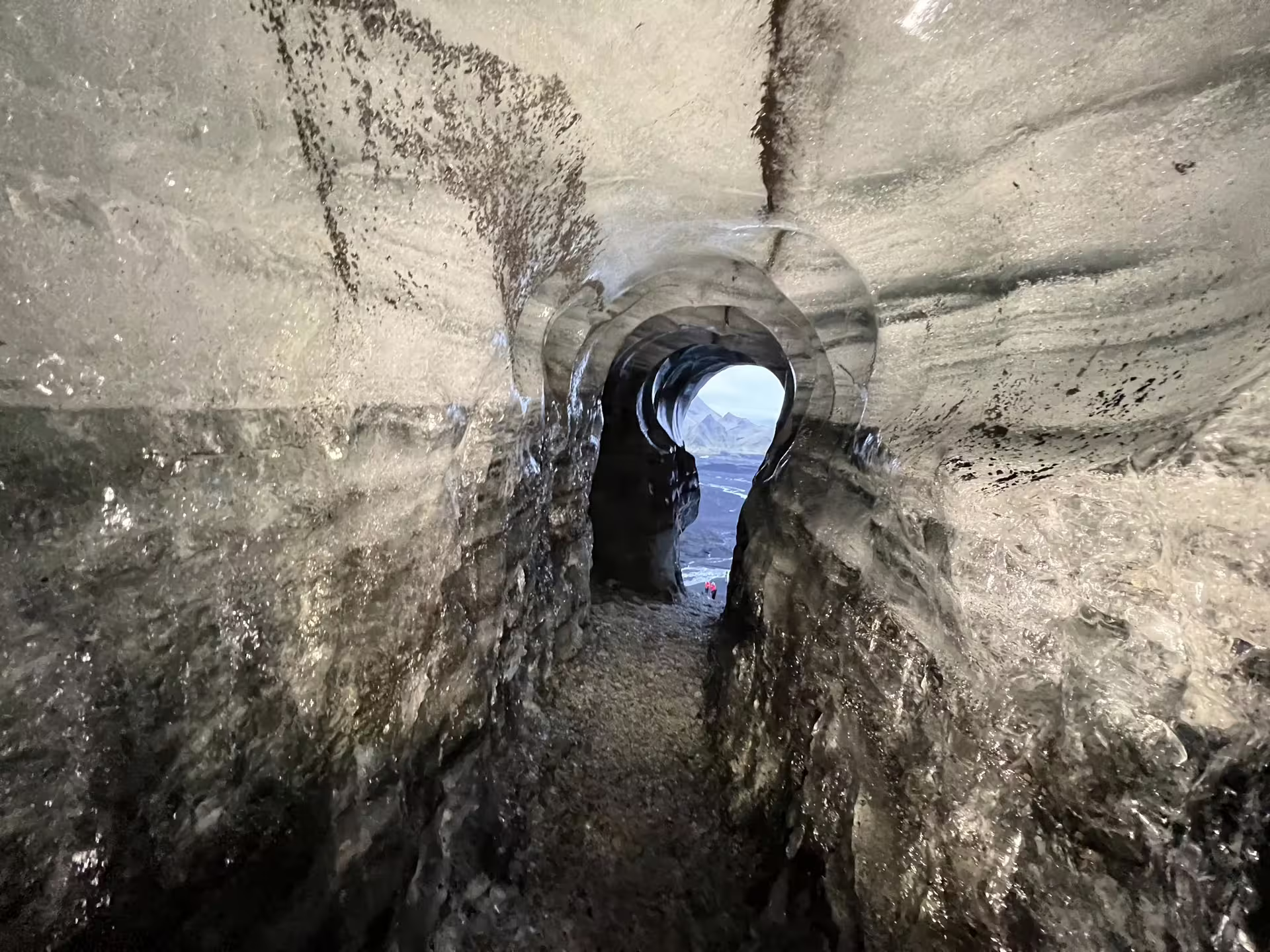 Stunning glacial ice tunnel opening revealing Myrdalsjokull landscape on guided Katla ice cave tour from Vik