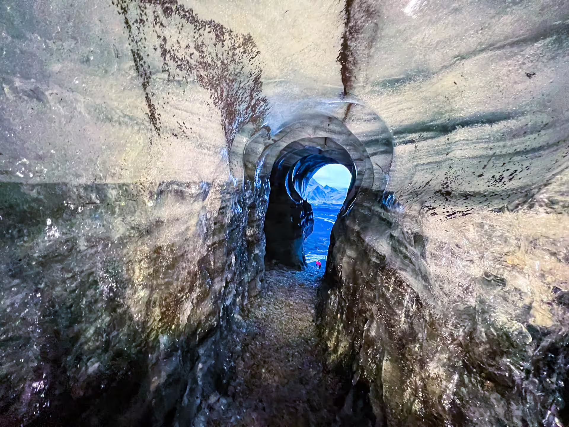 Inside Katla ice cave tunnel revealing breathtaking Iceland South Coast mountain views on a private Reykjavik day tour