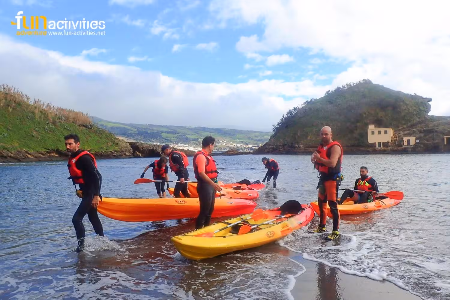 Group launching sea kayaks from the beach in Vila Franca do Campo, São Miguel, Azores guided tour