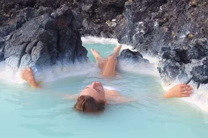 Relaxing in Iceland’s Blue Lagoon geothermal spa, ideal Keflavik Airport transfer tour to Blue Lagoon.