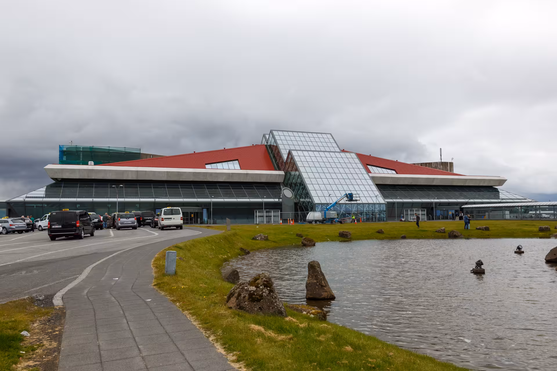 Keflavik International Airport KEF terminal building with red roof and glass facade, Iceland