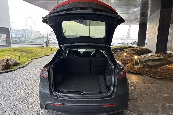 Spacious open trunk of a luxury vehicle for Keflavik Airport transfer to Reykjavik, ideal for luggage storage.