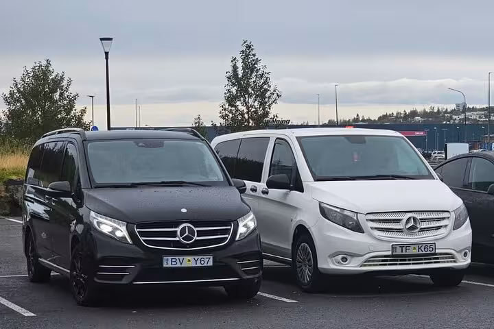 Black and white Mercedes vans ready for a private airport transfer service between Keflavik and Reykjavik.