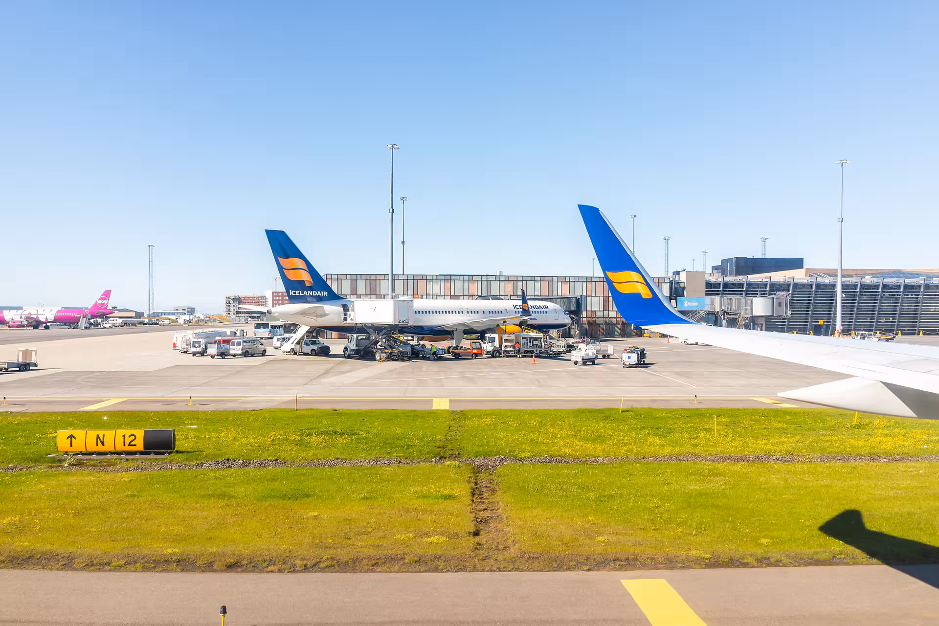 Keflavik International Airport apron with Icelandair jets, ideal for booking a private transfer to Reykjavik