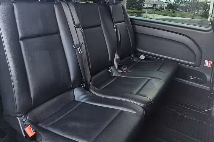 Spacious rear seating in a high-end vehicle for Keflavik Airport to Reykjavik private transfer service.