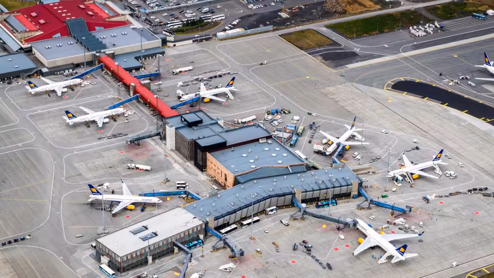 Aerial view of Keflavik International Airport with Icelandair planes at terminal gates