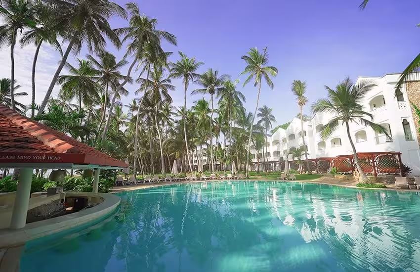 Luxury Kenya Coast resort pool surrounded by palm trees ideal for a 4-night guided golf tour stay