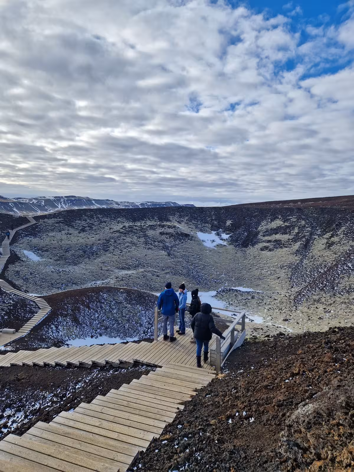 Tourists exploring Kerid volcanic crater on a wooden boardwalk during a private luxury Golden Circle Iceland tour