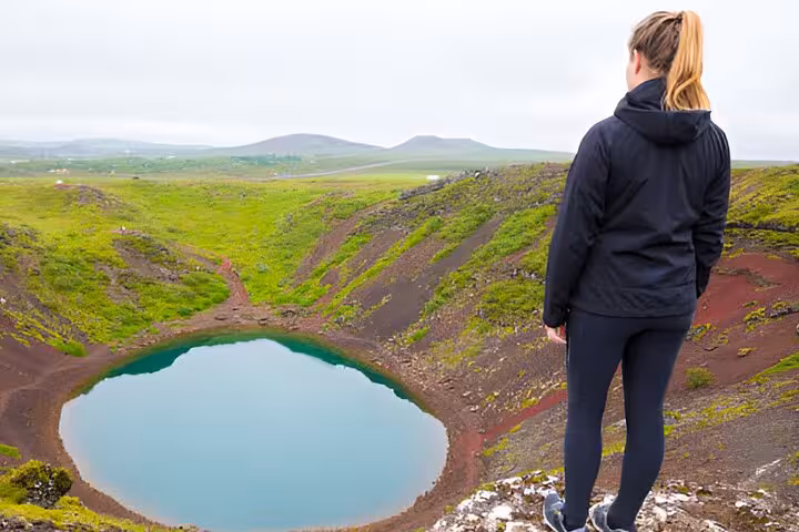 Woman overlooking Kerid volcanic crater lake on Golden Circle tour from Reykjavik
