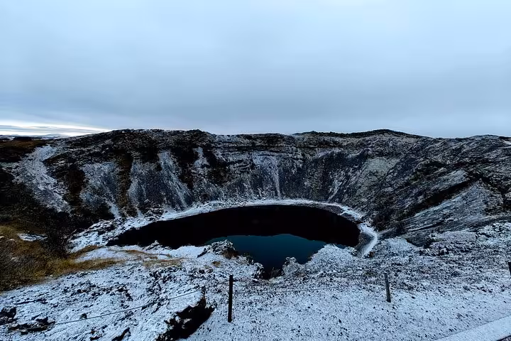 Kerid volcanic crater lake dusted with snow on Iceland's Golden Circle route
