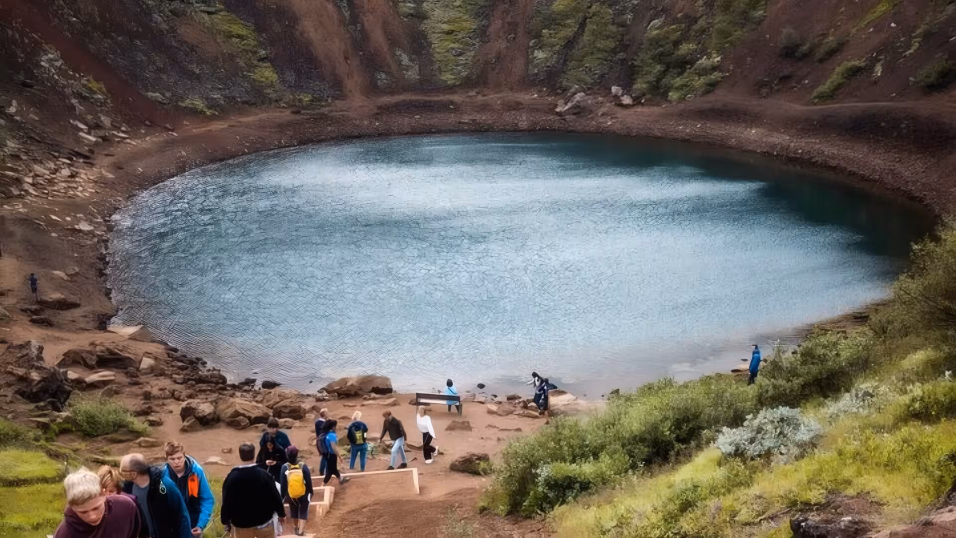 Tourists visiting Kerid volcanic crater lake on Iceland's Golden Circle tour