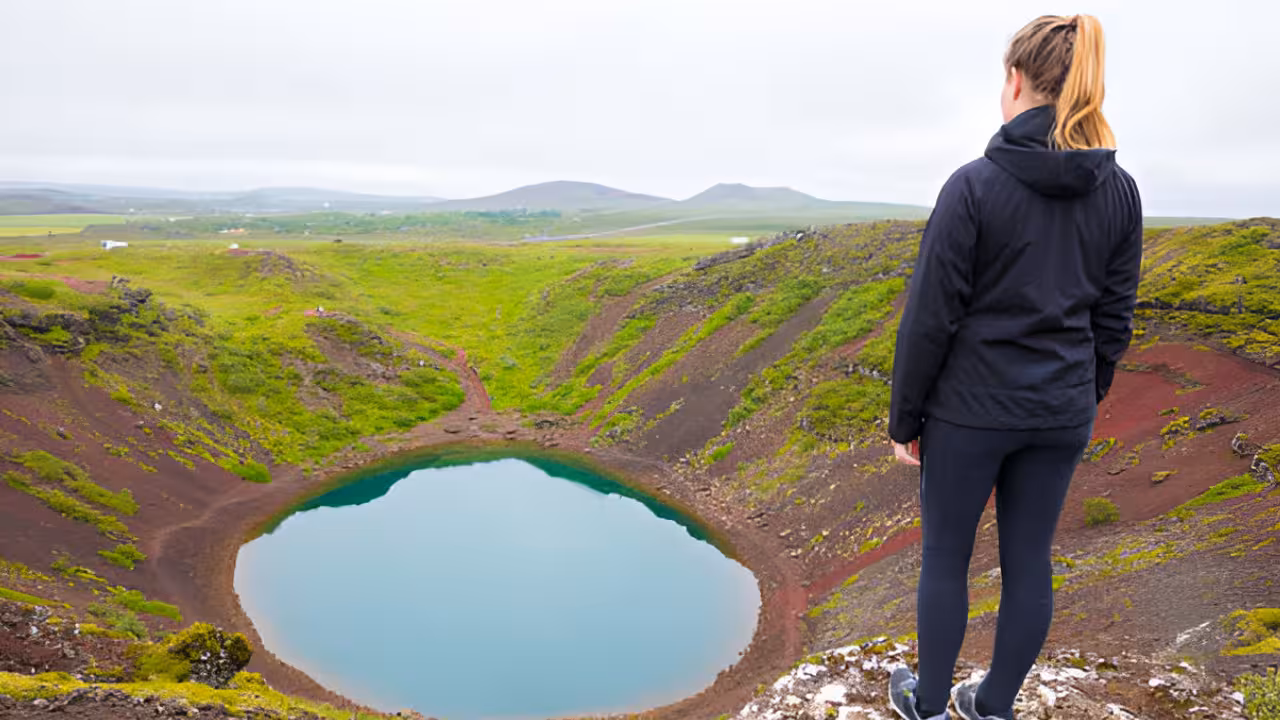 Woman overlooking Kerid volcanic crater lake on Iceland's Golden Circle tour